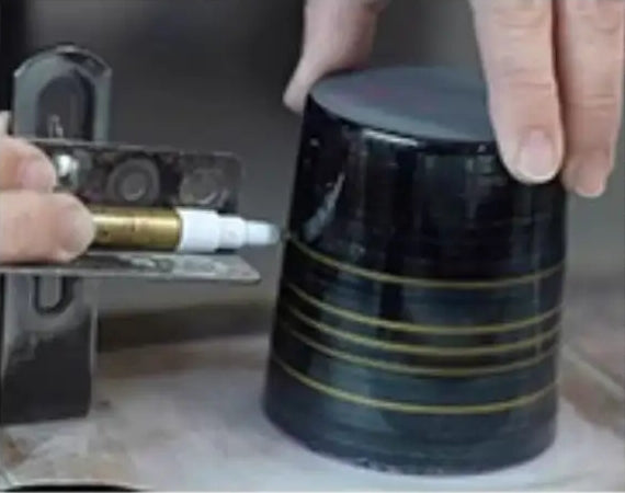 Hands marking guide lines on a glass — supplier-provided craft process illustration