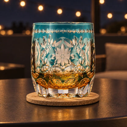 Flower Temari Edo Kiriko Whisky Glass, Amber Blue, with whisky and one ice cube — AI-generated nighttime styling